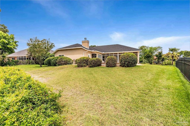 3756 Bengal Rd, Gulf Breeze, FL 32563 - back of house with a lawn, fence, and a chimney