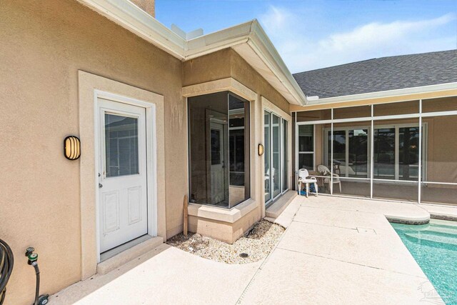 3756 Bengal Rd, Gulf Breeze, FL 32563 - entrance to property with a patio, a shingled roof, an outdoor pool, and stucco siding