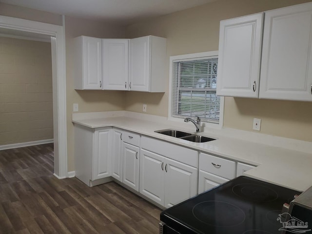 kitchen featuring sink, range with electric stovetop, dark hardwood / wood-style floors, and white cabinets