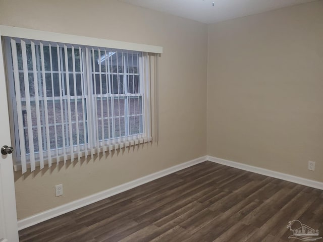 spare room featuring dark hardwood / wood-style flooring