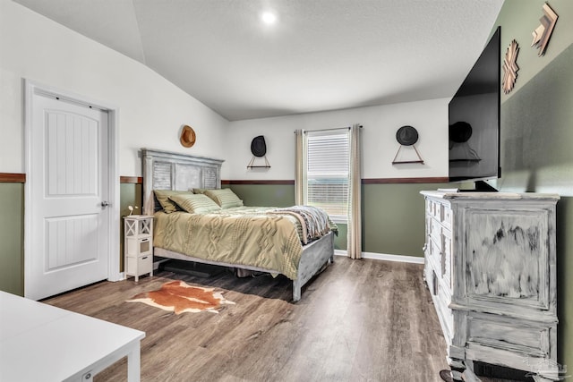 4744 Perception Cir, Milton, FL 32570 - bedroom featuring wood finished floors and vaulted ceiling