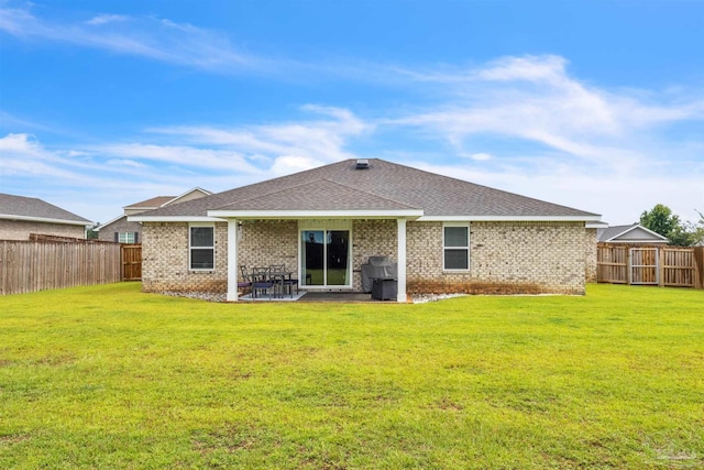 4744 Perception Cir, Milton, FL 32570 - rear view of house with brick siding, a fenced backyard, roof with shingles, and a patio