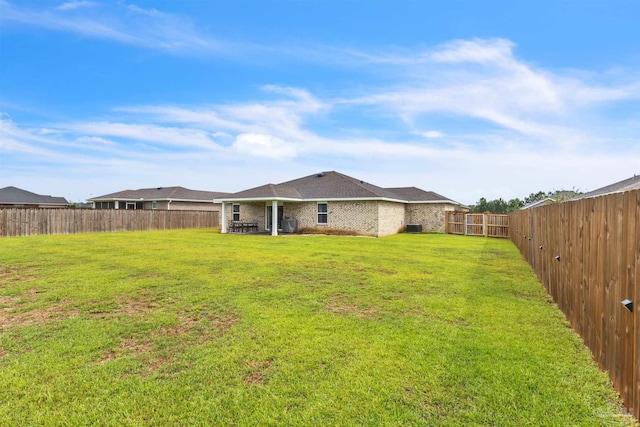 4744 Perception Cir, Milton, FL 32570 - back of property featuring a fenced backyard, a patio area, and brick siding