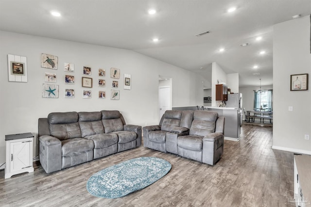 4744 Perception Cir, Milton, FL 32570 - living area featuring wood finished floors, recessed lighting, a chandelier, and lofted ceiling