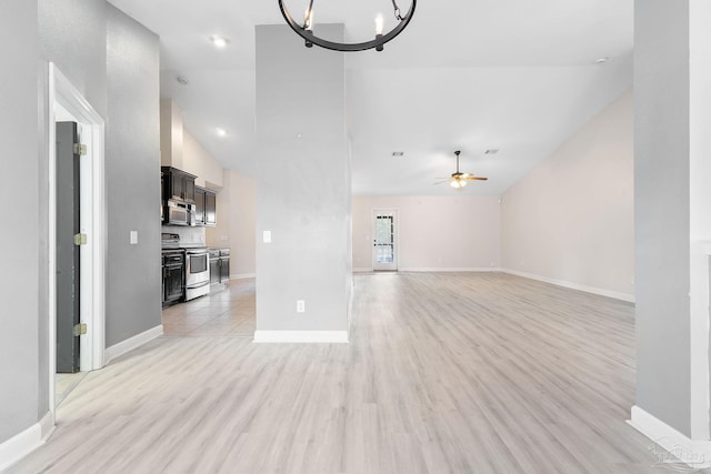 unfurnished living room featuring high vaulted ceiling, ceiling fan with notable chandelier, and light wood-type flooring