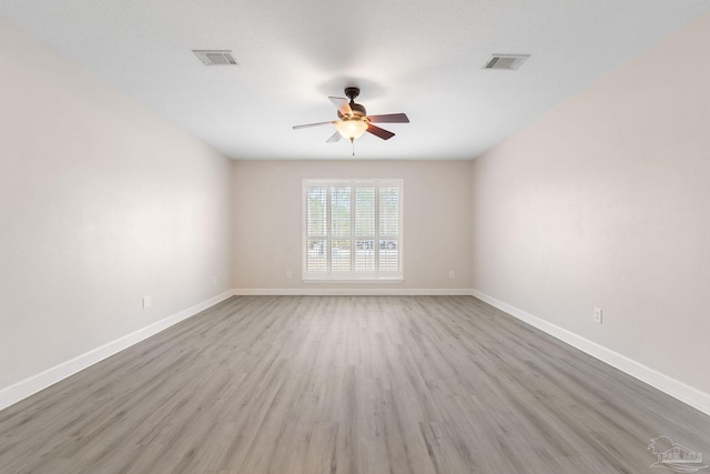 spare room featuring hardwood / wood-style flooring and ceiling fan