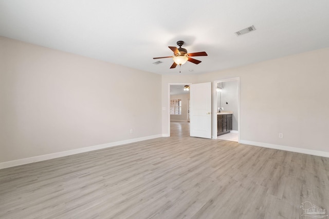 spare room with light hardwood / wood-style floors and ceiling fan