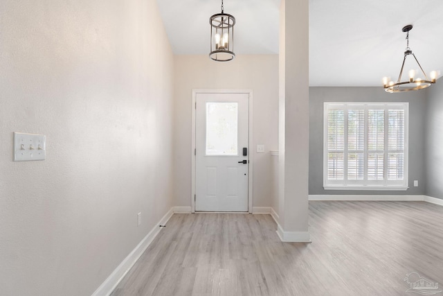 entryway featuring light hardwood / wood-style flooring and a notable chandelier