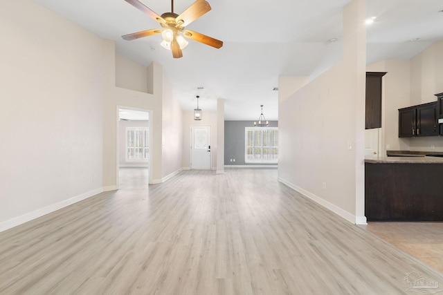 unfurnished living room featuring ceiling fan, high vaulted ceiling, and light hardwood / wood-style flooring