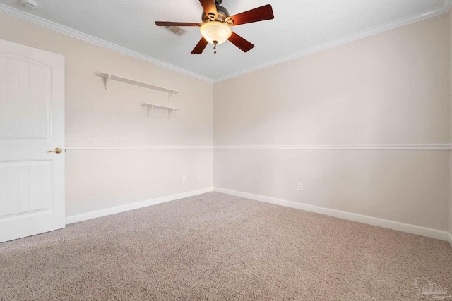 carpeted empty room featuring crown molding and ceiling fan