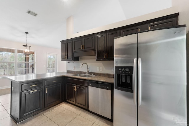 kitchen featuring sink, decorative light fixtures, kitchen peninsula, and appliances with stainless steel finishes