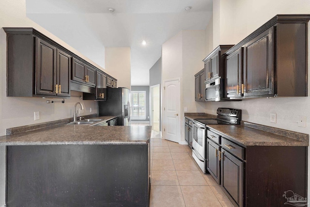 kitchen featuring appliances with stainless steel finishes, sink, light tile patterned floors, and dark brown cabinets