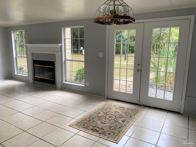 doorway to outside featuring a notable chandelier, french doors, and light tile patterned floors