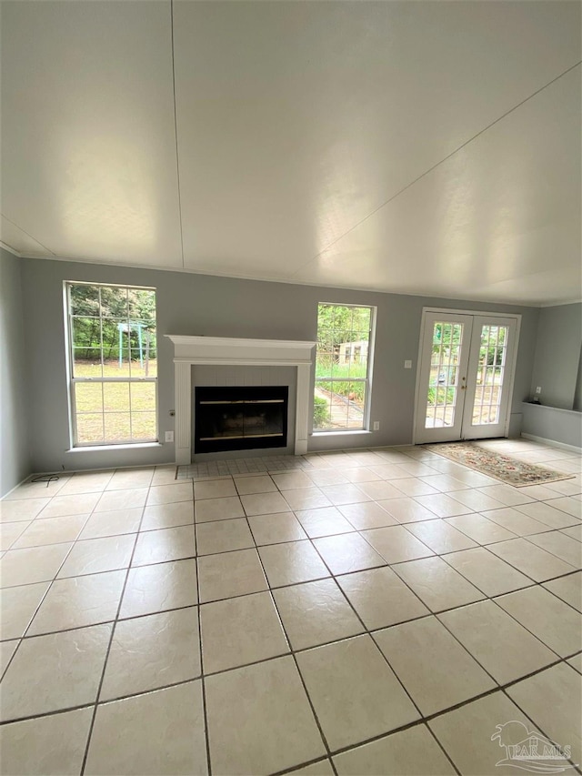 unfurnished living room featuring french doors and light tile patterned flooring