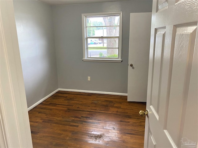 unfurnished room featuring dark hardwood / wood-style flooring