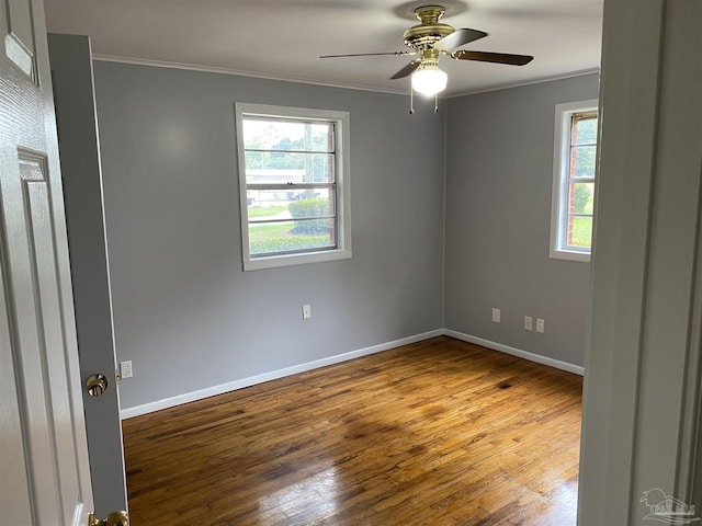 unfurnished room with ceiling fan, crown molding, and wood-type flooring