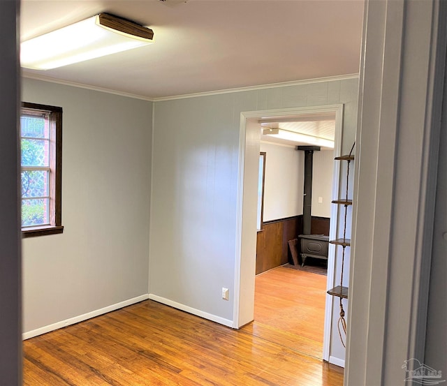 spare room with ornamental molding and wood-type flooring