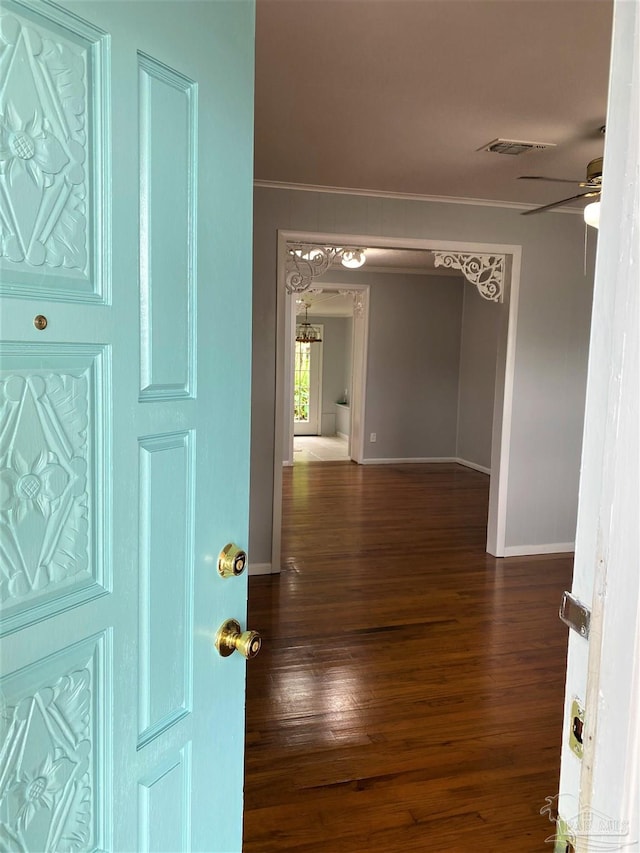 interior space featuring ornamental molding and dark hardwood / wood-style floors