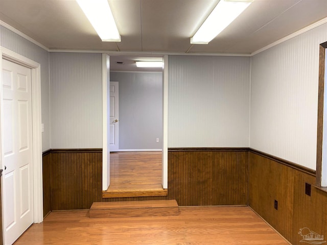 interior space featuring light wood-type flooring and crown molding