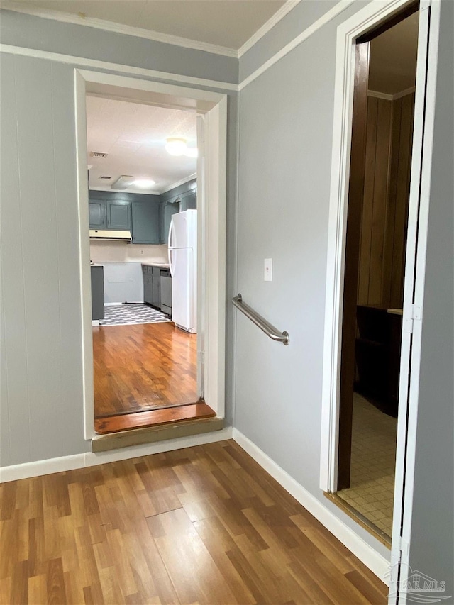 hall with ornamental molding and dark hardwood / wood-style flooring