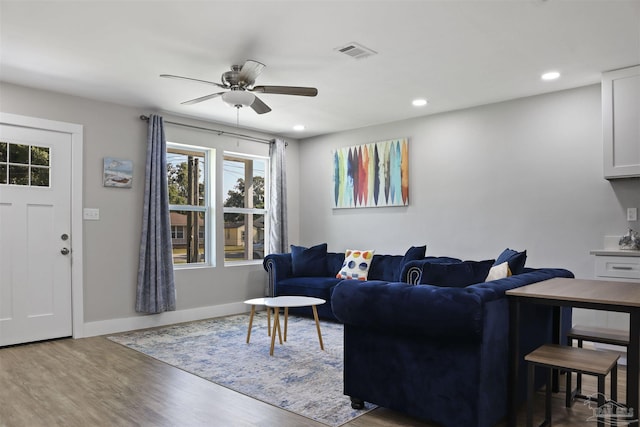 living room featuring hardwood / wood-style flooring and ceiling fan