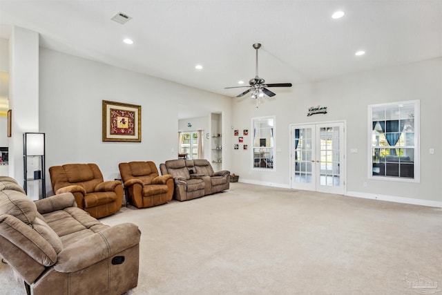 carpeted living room featuring ceiling fan and french doors