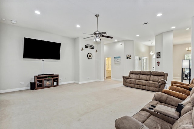 carpeted living room featuring ceiling fan