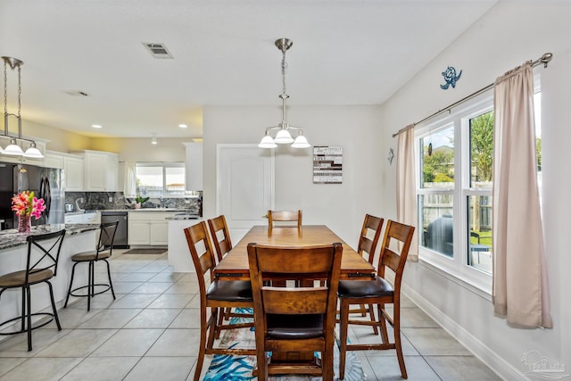 dining space with a chandelier and light tile patterned floors