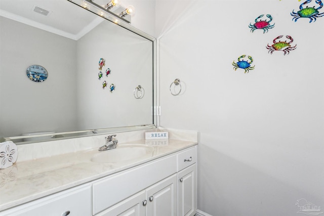 bathroom with vanity and crown molding