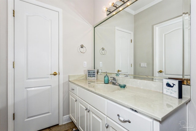 bathroom with ornamental molding and vanity