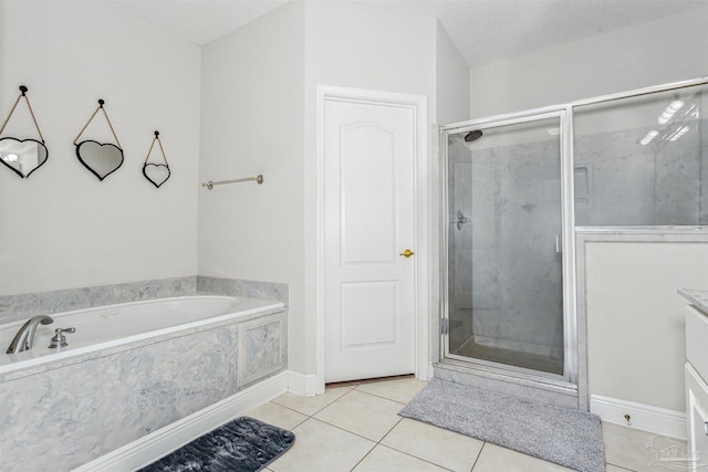 bathroom featuring plus walk in shower, tile patterned floors, vanity, and a textured ceiling