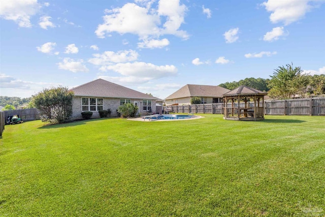 view of yard featuring a fenced in pool and a gazebo