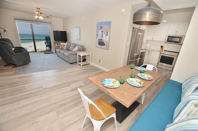 dining space featuring light hardwood / wood-style flooring and ceiling fan