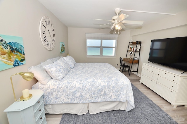 bedroom with light hardwood / wood-style floors and ceiling fan