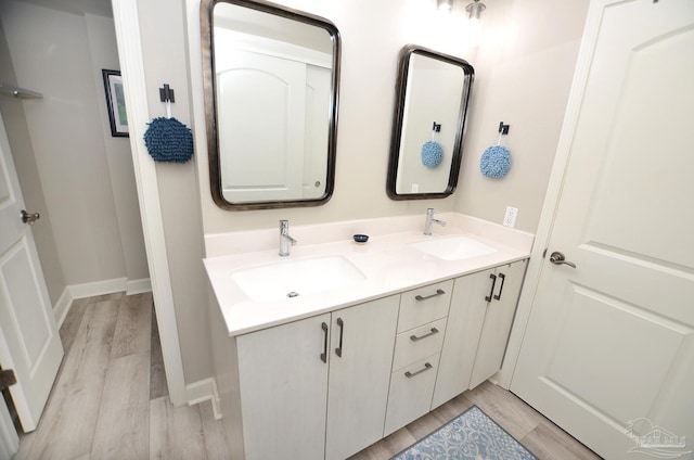 bathroom featuring hardwood / wood-style flooring and double sink vanity