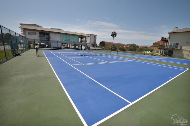 view of tennis court with fence