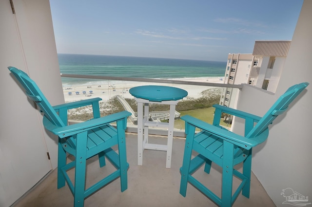 balcony with a water view and a beach view