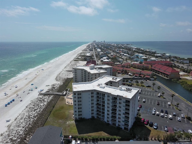 aerial view with a water view and a beach view