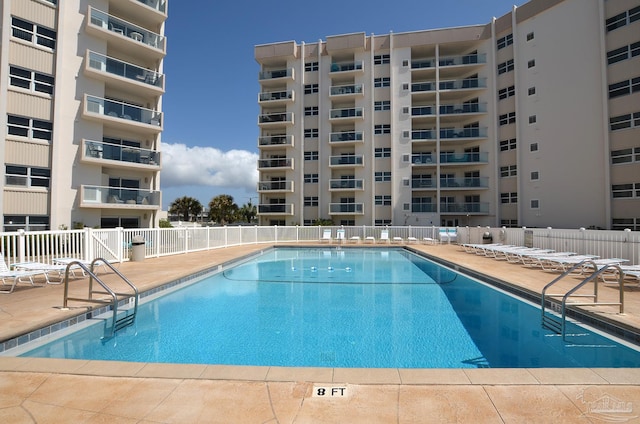 pool with fence and a patio