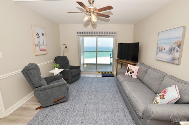 living room with ceiling fan and light hardwood / wood-style floors