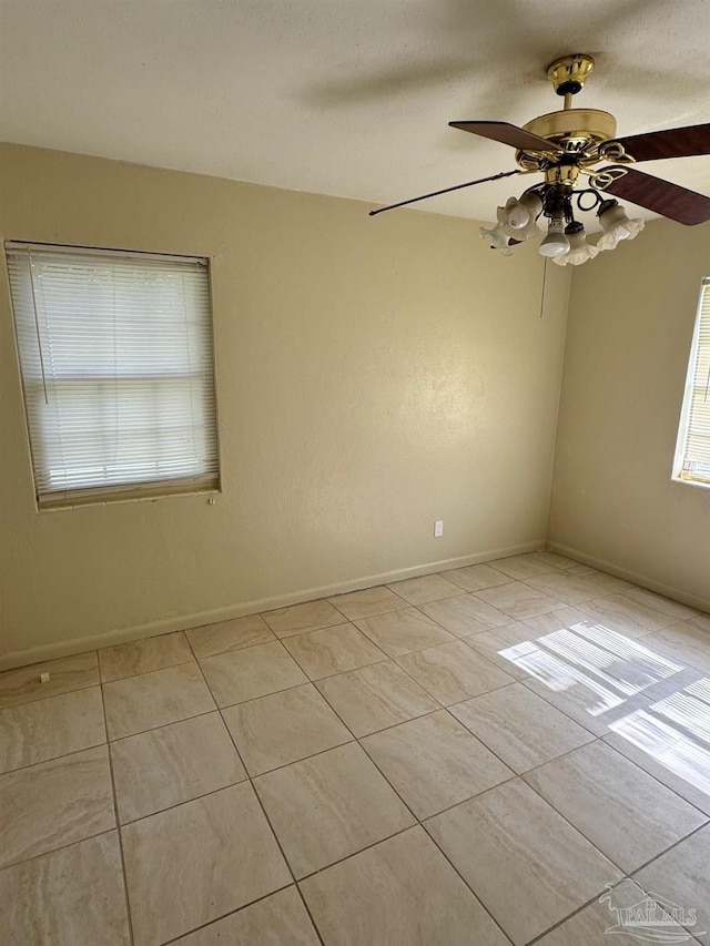 unfurnished room with baseboards, light tile patterned floors, and ceiling fan