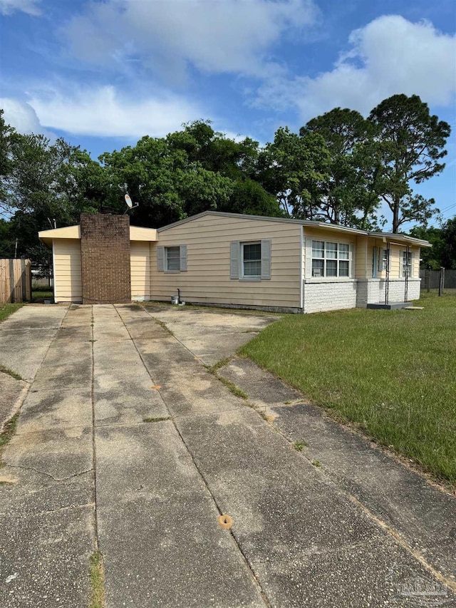 back of property with fence and a yard