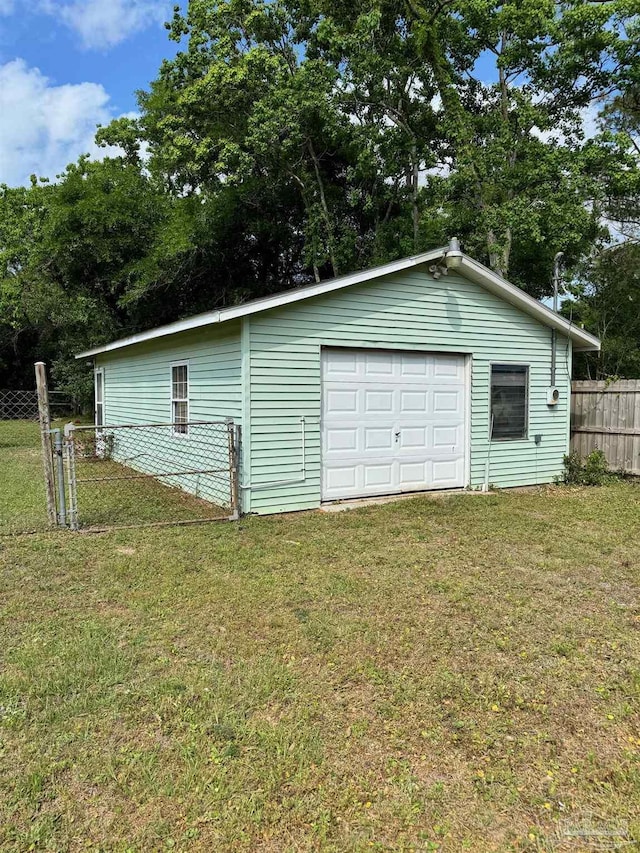 detached garage featuring fence
