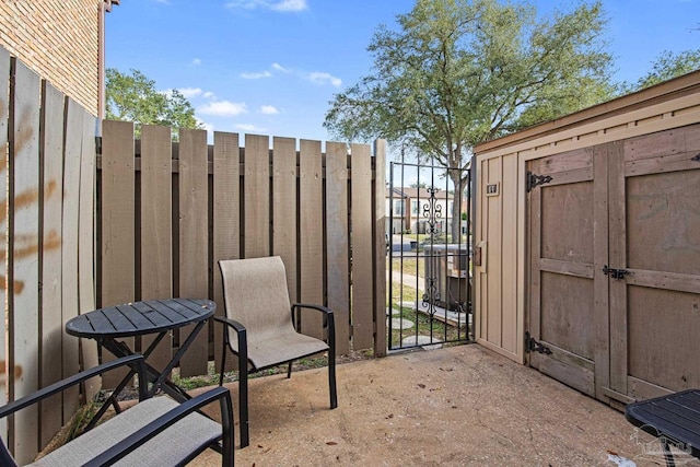 view of patio featuring a shed