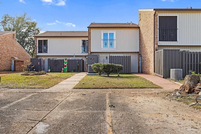 rear view of house with central AC unit