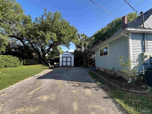 1726 N 15th Ave, Pensacola, FL 32503 - view of property exterior featuring asphalt driveway and a chimney