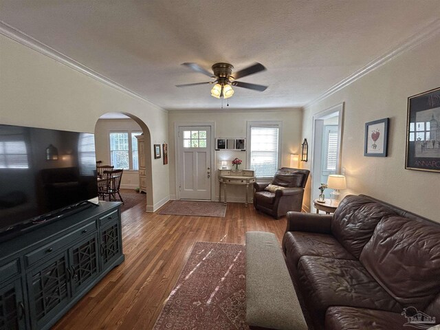 1726 N 15th Ave, Pensacola, FL 32503 - living room with arched walkways, ornamental molding, a ceiling fan, wood finished floors, and baseboards