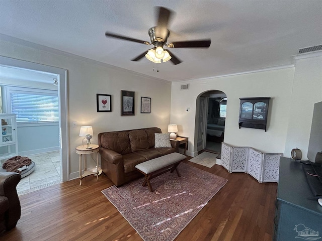 1726 N 15th Ave, Pensacola, FL 32503 - living area featuring arched walkways, ceiling fan, crown molding, wood finished floors, and baseboards