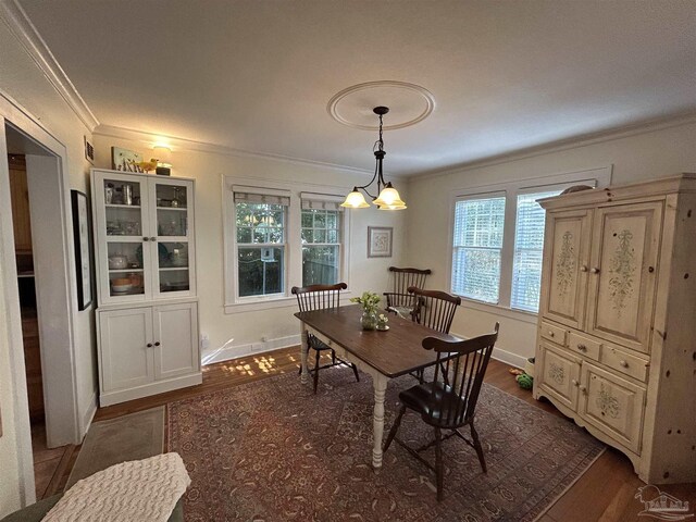 1726 N 15th Ave, Pensacola, FL 32503 - dining space featuring crown molding, dark wood-type flooring, and baseboards
