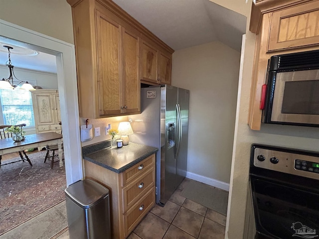 1726 N 15th Ave, Pensacola, FL 32503 - kitchen with stainless steel appliances, dark countertops, lofted ceiling, brown cabinetry, and baseboards